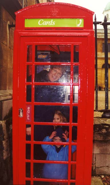 Kids (including John) in phone booth.